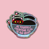 Holografische glitter sticker met een zwarte kat, rode bril en grappige Engelse tekst.